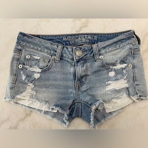 Distressed denim shorts with lace pocket detail